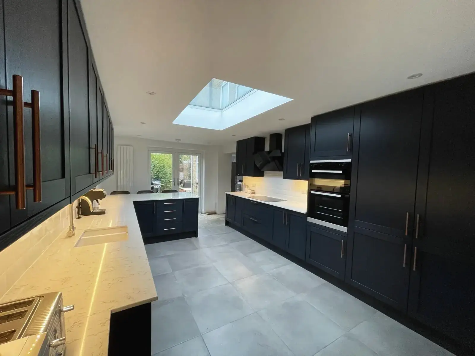 Kitchen refurbishment with large tiles and modern finishes